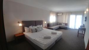 Postel nebo postele na pokoji v ubytování Family Hotel Muses