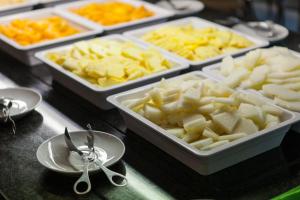 two trays of food sitting on a table with spoons at Alfagar Alto da Colina in Albufeira