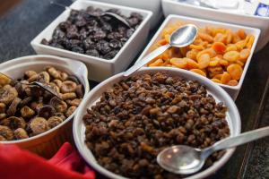 a table topped with bowls of food with spoons at Alfagar Alto da Colina in Albufeira