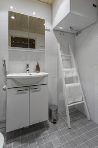 a white bathroom with a sink and a ladder at Vasko Luxurious Suites, Nilo in Rovaniemi
