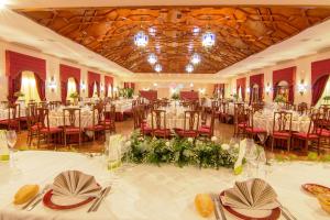 a banquet hall with white tables and chairs at Hotel Carmen in La Carlota +63 photos