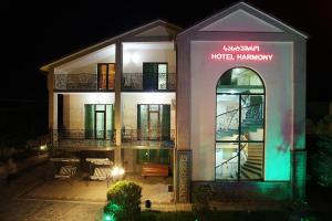 a building with a sign on it at night at Hotel Harmony in Kutaisi