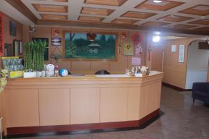 a lobby with a large counter in a room at Wankou Hotel in Zhongzheng
