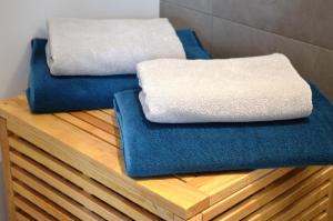 two towels sitting on top of a wooden table at Hochlandappartement in Dresden