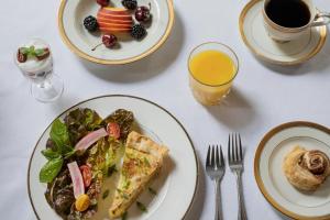 a table with plates of food and a cup of coffee at Hamilton Turner Inn in Savannah