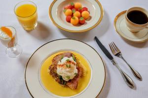 a table with two plates of food and a plate of fruit at Hamilton Turner Inn in Savannah