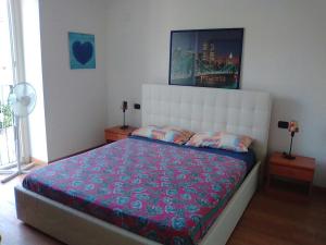 a bedroom with a large bed with a white headboard at La Supernova in Bergamo