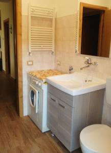 a bathroom with a sink and a washing machine at La Tavernetta in Randazzo