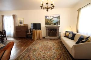 a living room with a couch and a fireplace at pdl house garden in Ponta Delgada