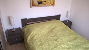 A bed or beds in a room at Gereben Apartman Pécs