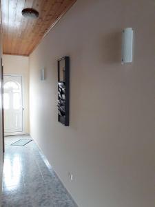 a room with a white wall with a picture on it at Mar de Prata in Maia