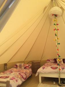 
A bed or beds in a room at Cong Glamping
