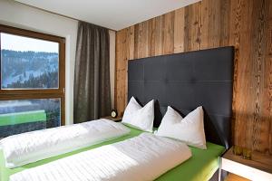 A bed or beds in a room at Familyparadies GAMPLALM