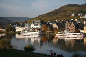 a town with boats in a lake with houses at Haus Weihertor in Traben-Trarbach