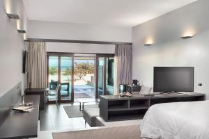 a hotel room with a bed and a television at Essenza Dune Hotel in Jericoacoara