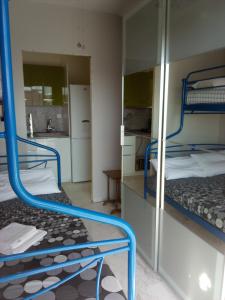 a room with two bunk beds and a kitchen at Apartment Elena in Piraeus