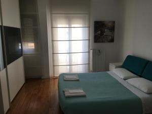 1 dormitorio con 1 cama verde y 1 sofá en Flowers Apartment, en Bari