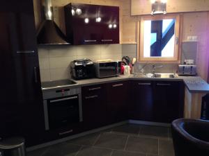 a kitchen with a sink and a microwave at La combe in Morzine