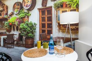 a table with a bottle of wine and a lamp at Bed&Bath Luxury Apartments in Krakow +290 photos