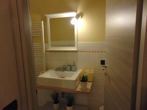 a bathroom with a white sink and a mirror at Gessi Charming Apartments in Florence