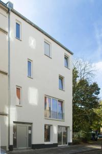 a white building with a balcony at Apartment11 Wartburg in Cologne