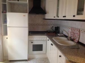 Una cocina o kitchenette en A.T. La Plaza