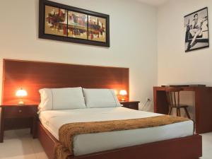 Giường trong phòng chung tại Hotel Boutique High Park