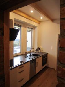 a kitchen with a sink and a window and a stove at Ferienwohnung Eichelgasse Wertheim in Wertheim