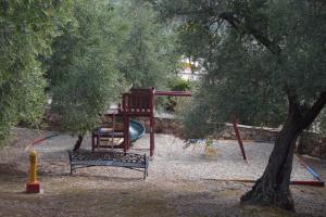 a playground with a slide and a tree at Casas Rurales Cortijo la Cañada in Estepa