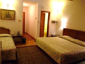 A bed or beds in a room at Classic Hotel
