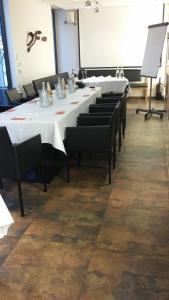 a row of tables and chairs in a room at Schlosshotel Bergzaberner Hof in Bad Bergzabern