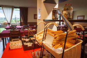 a basket of bread on a table in a restaurant at Aparthotel La Vall Blanca in Vielha