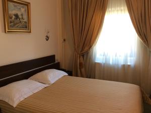 Postel nebo postele na pokoji v ubytování Hotel Kilometrul Zero