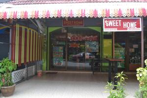 a store front of a surf shop with surfboards in the window at Sweet Home Patong in Patong Beach