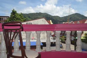 a chair sitting on top of a balcony at Sweet Home Patong in Patong Beach