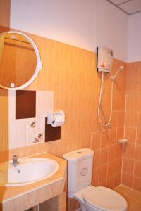 a bathroom with a sink and a toilet and a mirror at Sweet Home Patong in Patong Beach