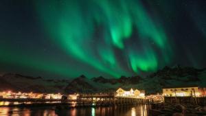 an image of the aurora in the sky over a town at Mefjord Brygge in Mefjordvær