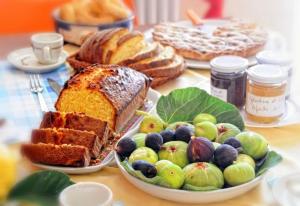 a table topped with plates of bread and fruit at Bed & breakfast "MAZZINI" in Leverano