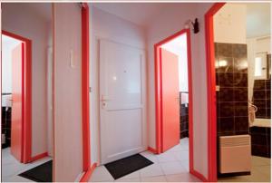 a hallway with two open doors in a room at Logis Hotels - Hotel Restaurant l Enclos in Donneville +27 photos