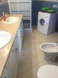 a bathroom with a washing machine and a washer and dryer at Apartment South Tenerife in San Miguel de Abona