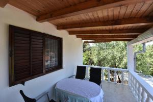 a balcony with a table and a window at Apartmani Marko in Gdinj