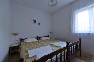 a bedroom with a bed with towels on it at Apartmani Marko in Gdinj