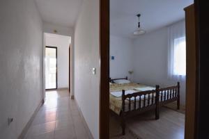 a bedroom with a bed in the middle of a room at Apartmani Marko in Gdinj