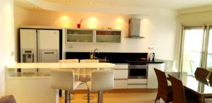 a kitchen with a table and chairs in a room at City Resort Palmore in Eilat