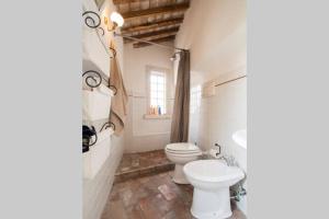 a bathroom with a toilet and a sink at Attico con Terrazza panoramica vista lago - LAKEHOLIDAY IT in Castel di Tora +116 photos