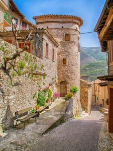 a stone building with a bench on a street at Attico con Terrazza panoramica vista lago - LAKEHOLIDAY IT in Castel di Tora