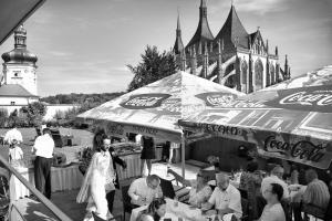 a group of people sitting at tables under umbrellas at Penzion a Restaurant Barbora in Kutná Hora