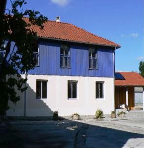 a blue and white house with a red roof at Lou Lombrès in Lombrès