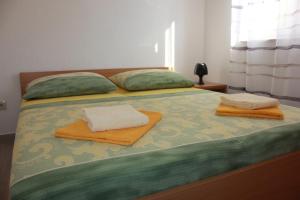 Postel nebo postele na pokoji v ubytování Apartments Roko