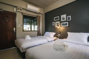 Postel nebo postele na pokoji v ubytování Cozy Inn Chiang Mai